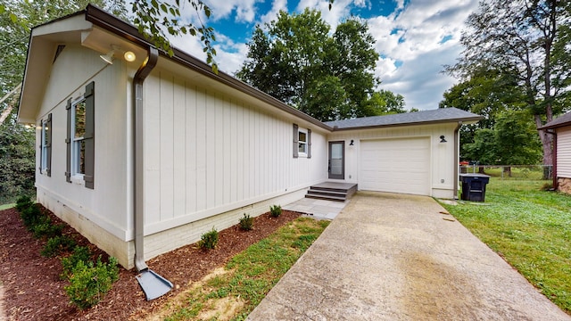 view of front of property with a front yard and a garage