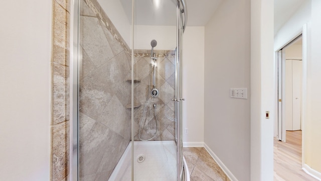 bathroom featuring walk in shower and hardwood / wood-style floors