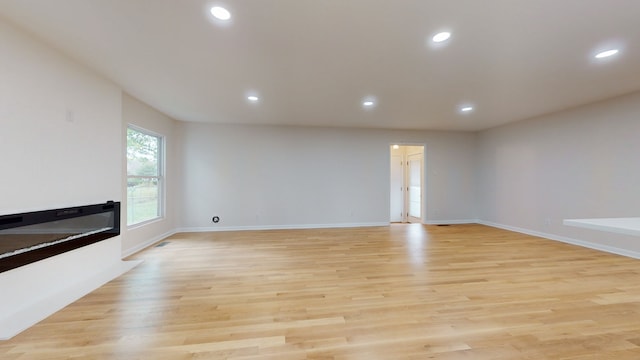 unfurnished living room with light hardwood / wood-style flooring