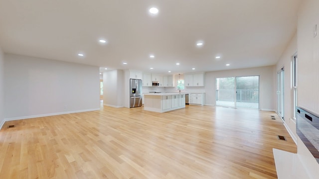 unfurnished living room with light hardwood / wood-style flooring