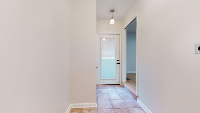 corridor with light tile patterned floors