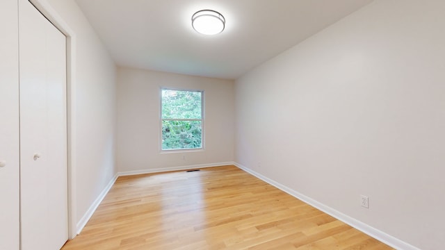 unfurnished room with light hardwood / wood-style floors