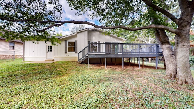 back of property featuring a yard and a wooden deck