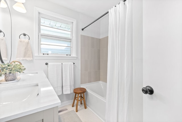 bathroom featuring vanity, shower / bath combo with shower curtain, and tile patterned floors