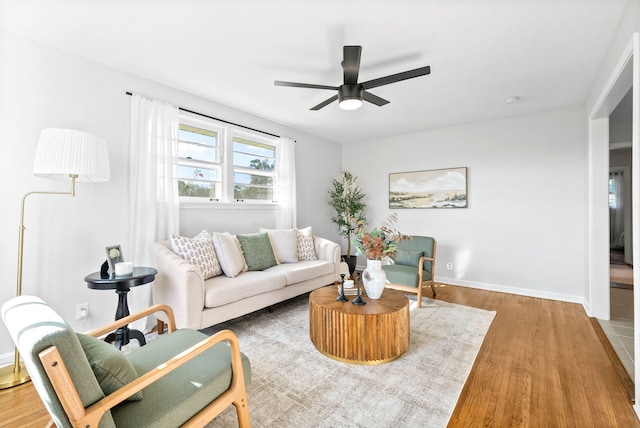 living room featuring ceiling fan and hardwood / wood-style flooring