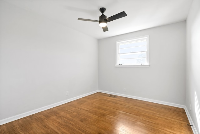 spare room with wood-type flooring and ceiling fan