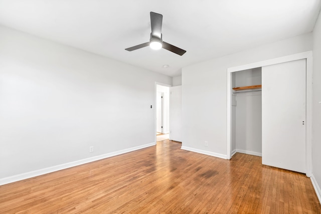 unfurnished bedroom with a closet, wood-type flooring, and ceiling fan