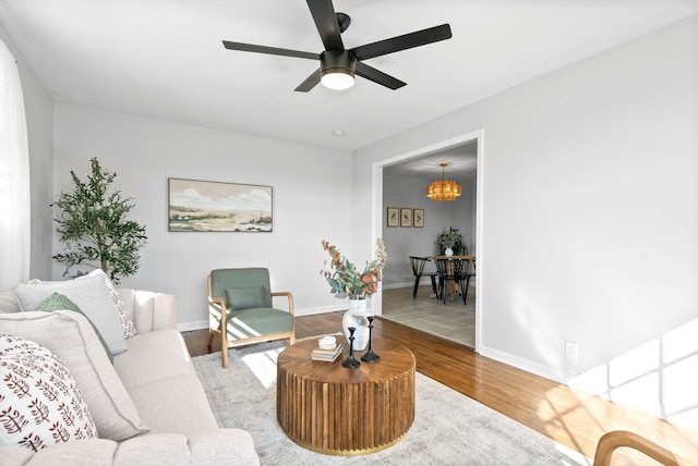 living room featuring light wood-type flooring and ceiling fan