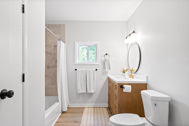 full bathroom with shower / bath combo, hardwood / wood-style flooring, vanity, and toilet