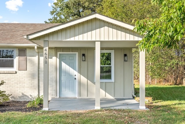 doorway to property with a lawn