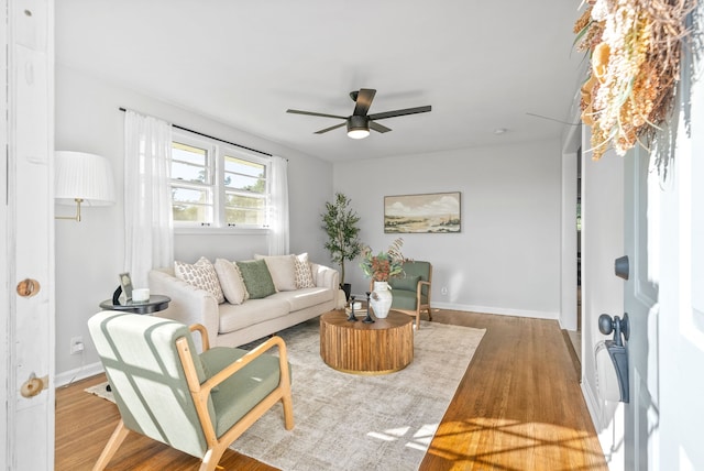 living room with light wood-type flooring and ceiling fan