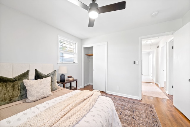 bedroom with ceiling fan, a closet, and hardwood / wood-style flooring