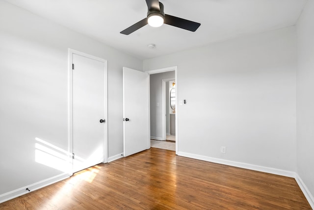 unfurnished bedroom featuring ceiling fan and hardwood / wood-style flooring