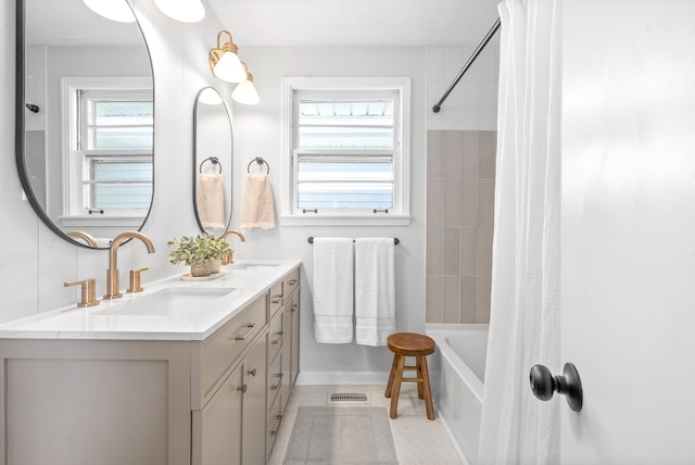 bathroom with shower / bath combo with shower curtain, tile patterned floors, and vanity