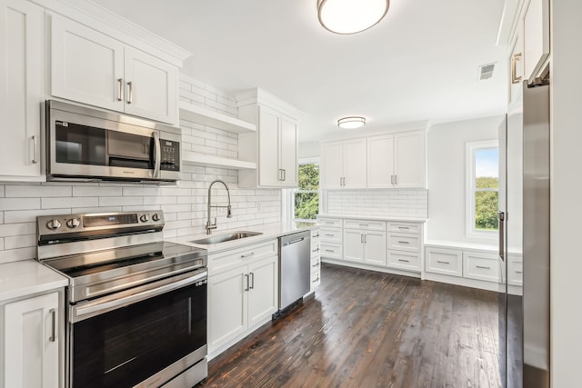 kitchen with white cabinetry, sink, stainless steel appliances, and dark hardwood / wood-style flooring