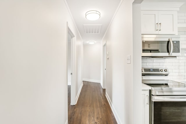 corridor featuring crown molding and dark hardwood / wood-style floors