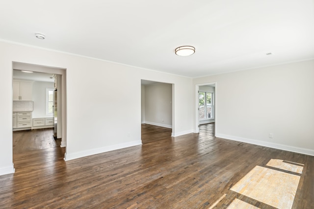 unfurnished room featuring crown molding and dark hardwood / wood-style flooring