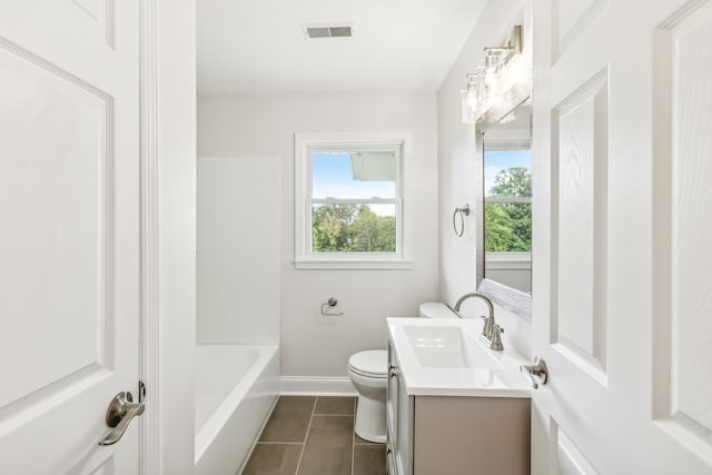 bathroom with vanity, tile patterned flooring, and toilet