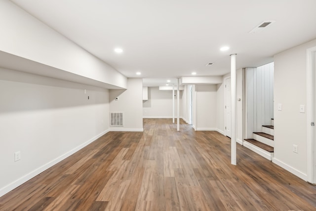 basement with dark hardwood / wood-style flooring