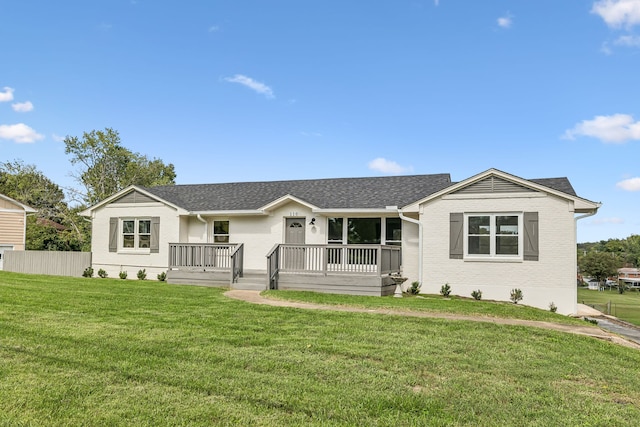 ranch-style home with a front lawn and a deck