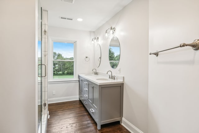 bathroom with a shower with door, vanity, and hardwood / wood-style flooring