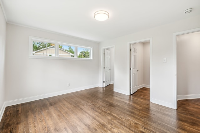 unfurnished bedroom with dark wood-type flooring