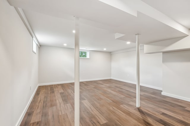 basement with hardwood / wood-style flooring