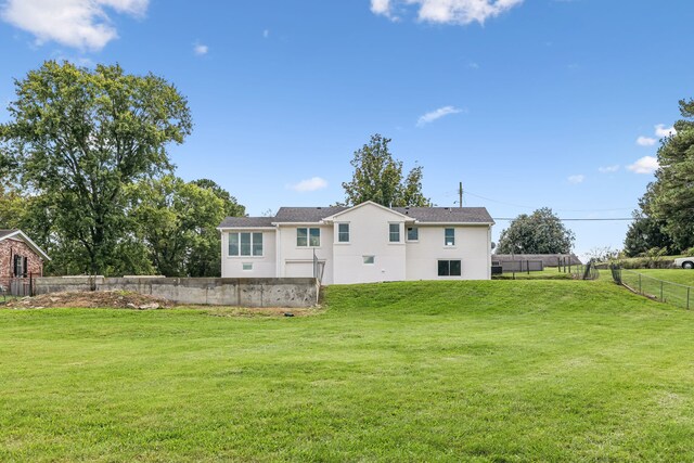 rear view of house with a lawn