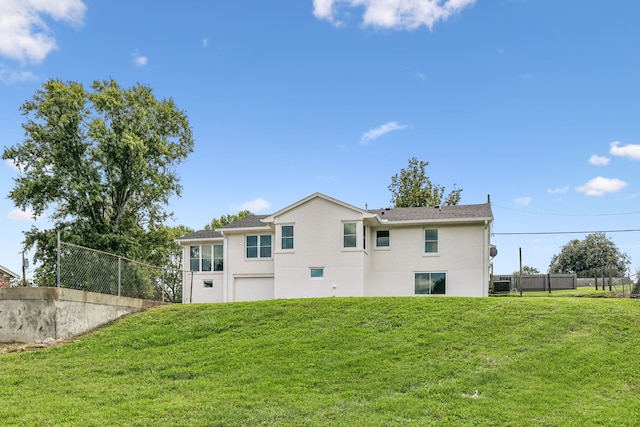 rear view of property featuring a lawn