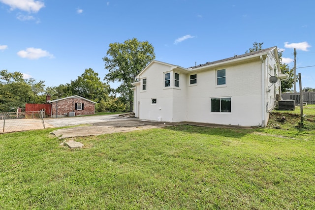 back of house with a lawn, a patio, and central AC unit