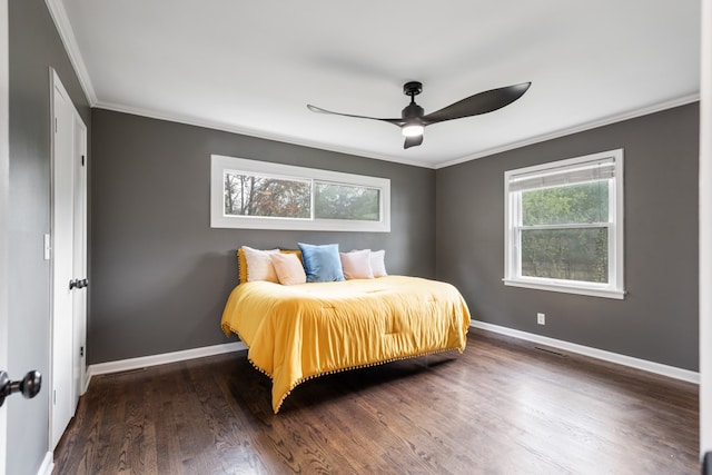 bedroom featuring ceiling fan, dark hardwood / wood-style floors, and crown molding