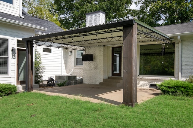 rear view of property featuring a lawn and a patio