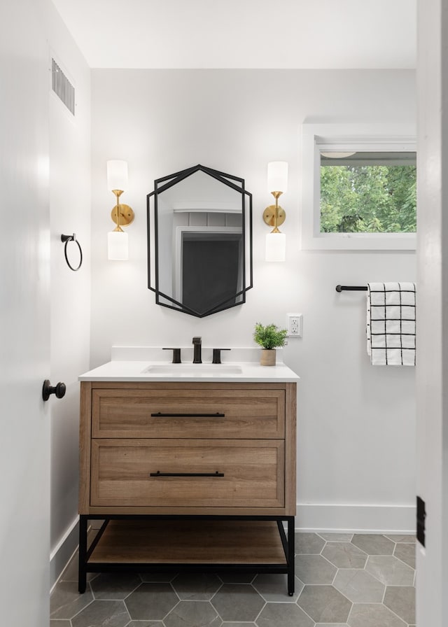 bathroom featuring tile patterned flooring and vanity