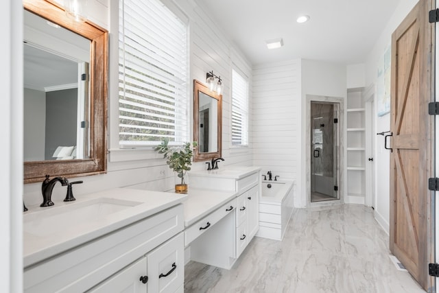 bathroom with vanity and shower with separate bathtub