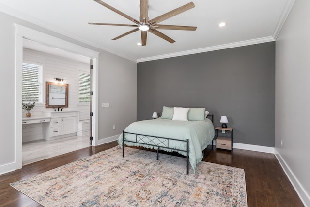 bedroom featuring ensuite bath, ceiling fan, dark wood-type flooring, and crown molding