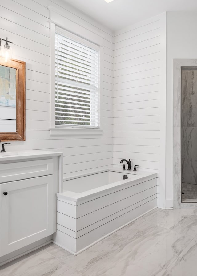 bathroom featuring shower with separate bathtub and vanity