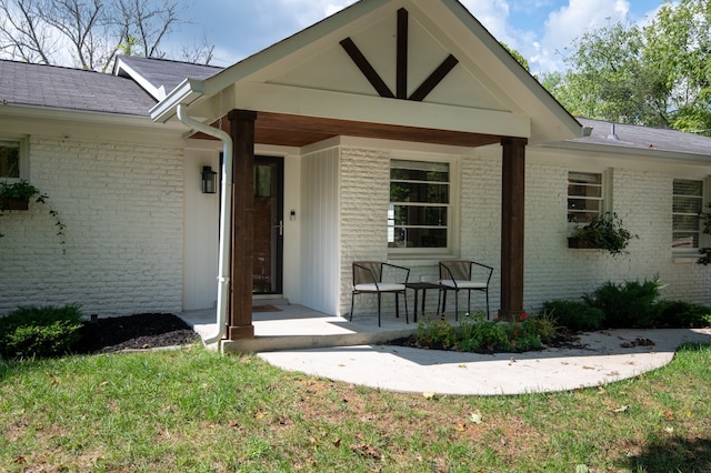 property entrance with a lawn