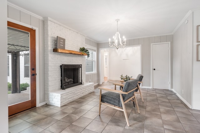 tiled dining space featuring a healthy amount of sunlight, a fireplace, crown molding, and a notable chandelier