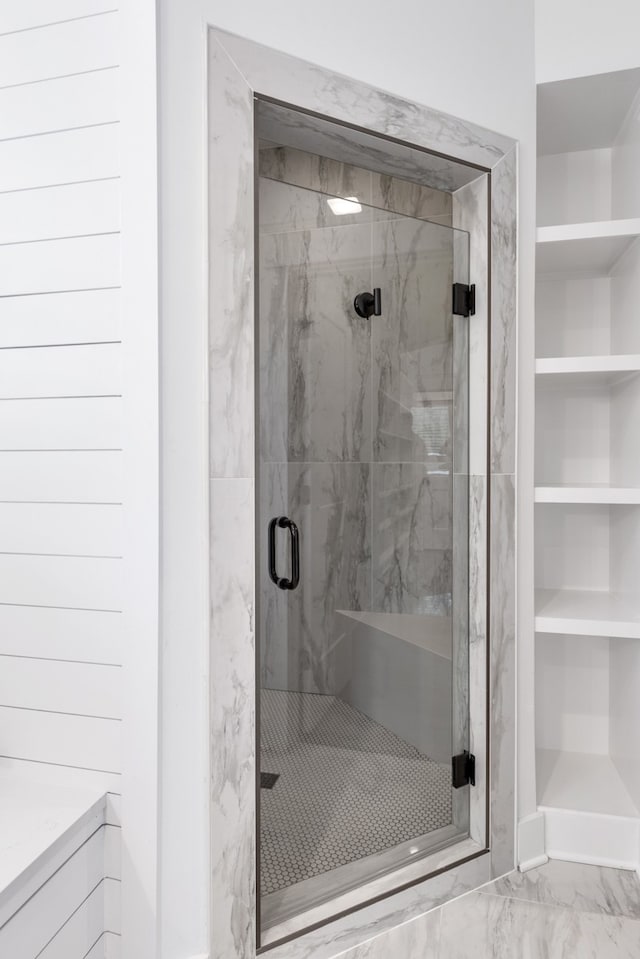 bathroom with built in features and an enclosed shower