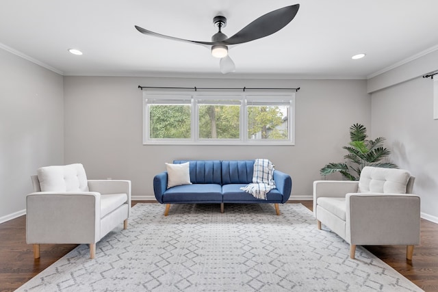 interior space with ornamental molding, hardwood / wood-style floors, and ceiling fan