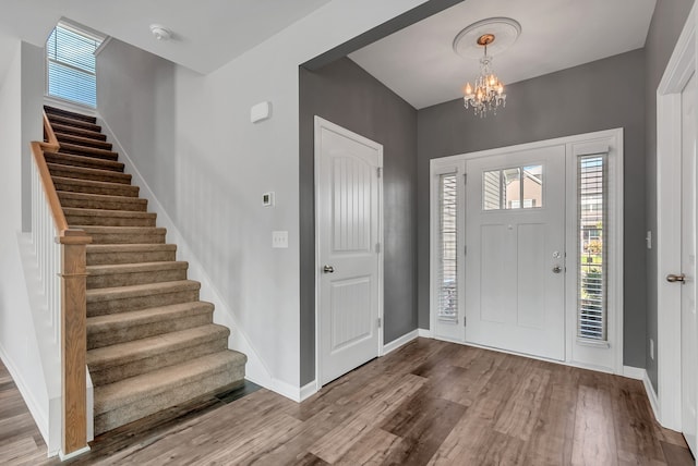 foyer entrance featuring a notable chandelier and hardwood / wood-style floors