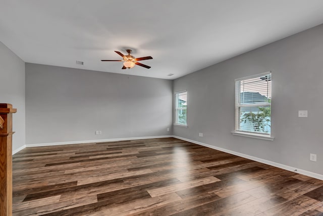 unfurnished room with ceiling fan and dark hardwood / wood-style flooring