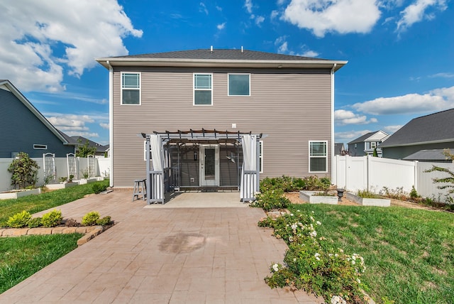 rear view of house featuring a patio, a pergola, and a yard