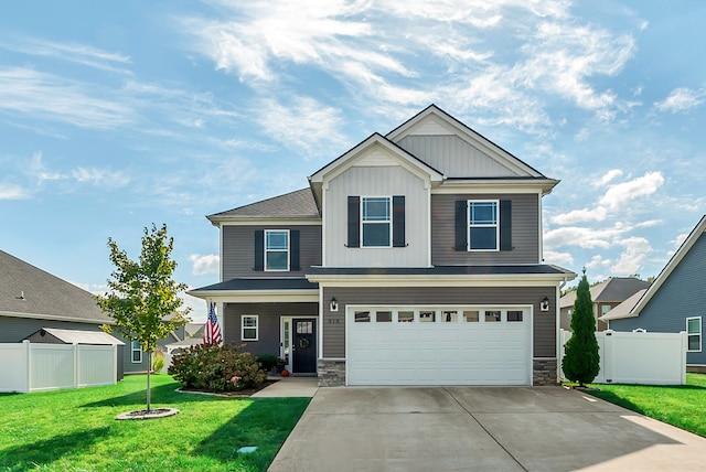 view of front of house with a garage and a front lawn