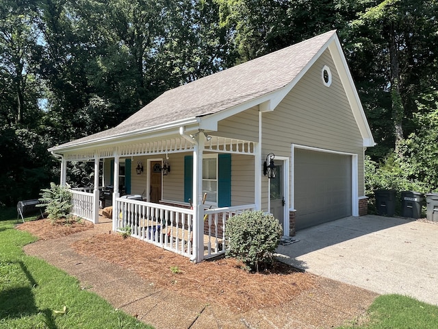 view of front of house with ceiling fan, a porch, and a garage