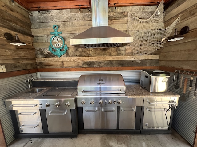 exterior space with wood-type flooring, wooden walls, sink, and extractor fan