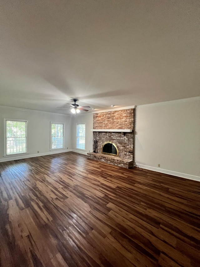 unfurnished living room featuring a brick fireplace, ceiling fan, and dark hardwood / wood-style floors