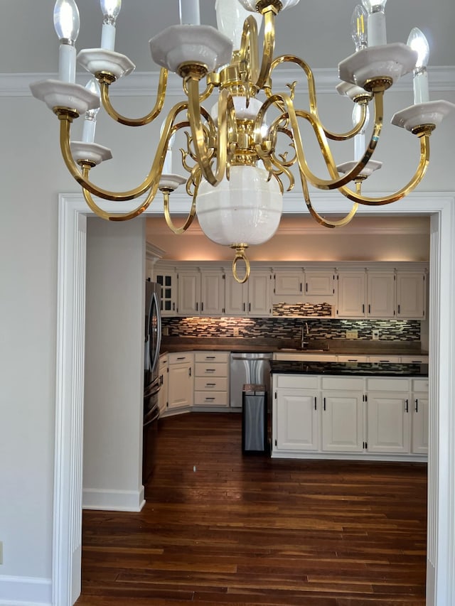 kitchen featuring backsplash, dark wood-type flooring, and white cabinets