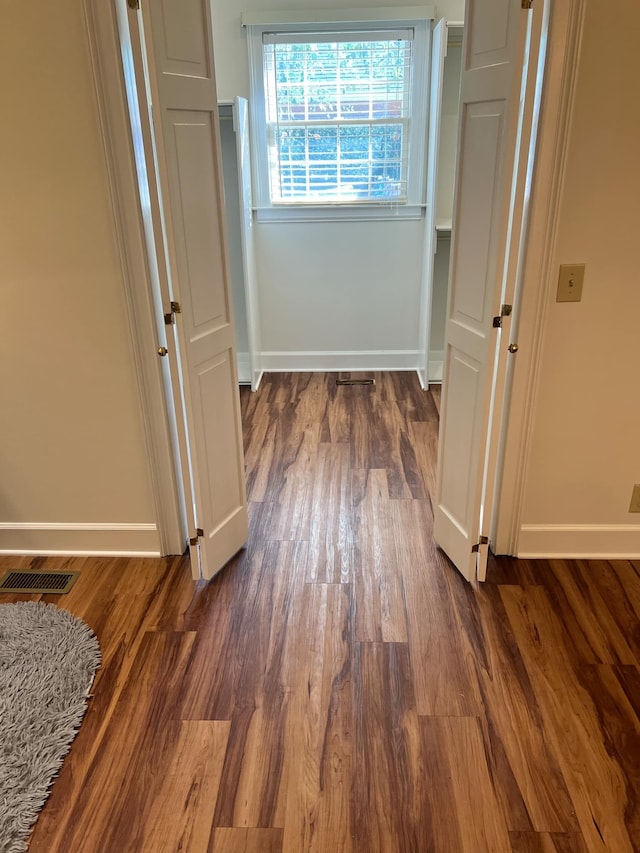 corridor featuring dark hardwood / wood-style floors