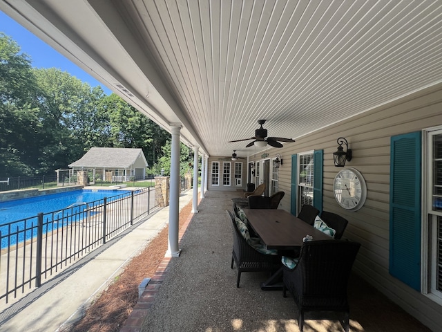 view of patio featuring ceiling fan and a fenced in pool